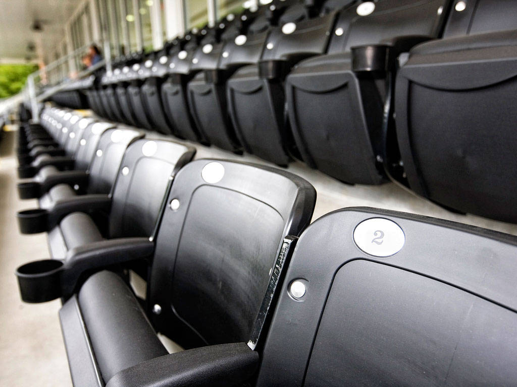 Stock photo of an empty row of stadium seats.